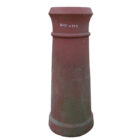 A lichen stained terracotta cannon top chimney pot with worn patina