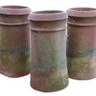 A rare set of 3 terracotta cannon top chimney pots with a consistent but individual patina