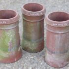 A set of 3 reclaimed terracotta chimney pots with authentic weathering