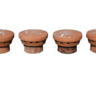 A terracotta cap, or 'Elephants Feet' for disused chimneys, showing a light patina.
