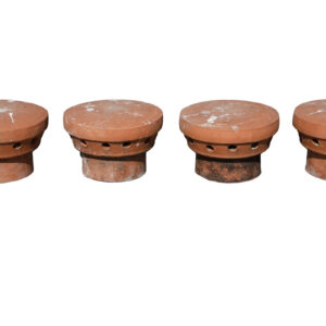 A terracotta cap, or 'Elephants Feet' for disused chimneys, showing a light patina.