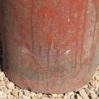Detail shot of a reclaimed pepper pot chimney pot showing the remnants of paint, wear at the base and environmental discolouration. A fabulous patina that creates visual impact in any garden setting
