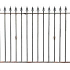 A section of reclaimed wrought iron spear top railings showing a rich patina of peeling paint and surface corrosion