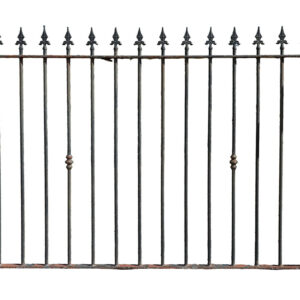 A section of reclaimed wrought iron spear top railings showing a rich patina of peeling paint and surface corrosion