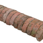 A run of antique red half round wall copings showing natural weathering and remnants of lime mortar