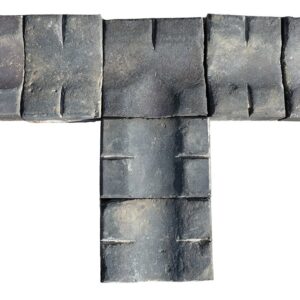 A unique and weathered collection of blue double stable gully pavers with both straight and T sections