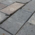 New Staffordshire blue brick pavers in stretcher bond pattern, showing the mild patina of storage.