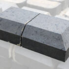 Reclaimed solid blue double cant end copings with a light patina and remnants of mortar
