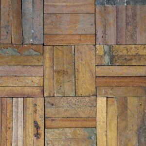 Reclaimed oak finger parquet flooring showing its aged patina of varnish, various marks and remnants of prior installation