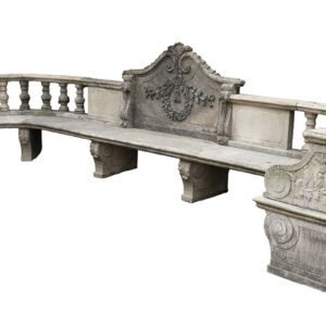 A magnificent stone garden seat with hand carved details and a lush patina showing its years spent exposed to the British weather