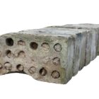 Detail of reclaimed Cambridge calf nose bricks showing a heavy patina of age and prior use, and the mortar filled perforations of mid 20th century.