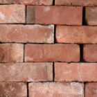 Reclaimed and weathered wirecut bricks from Leicester, showing a fine patina that creates visual interest in a blank wall.