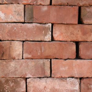 Reclaimed and weathered wirecut bricks from Leicester, showing a fine patina that creates visual interest in a blank wall.