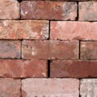 Reclaimed and weathered wirecut bricks from Leicester, showing a fine patina that creates visual interest in a blank wall.