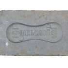 Reverse detail of a reclaimed patterned blue paver showing the historical mark of the manufacturer Cakemore
