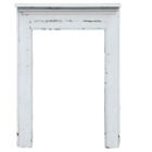 A white painted reclaimed pine fire surround showing its age through peeling paint and worn edges