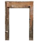 Reverse side of a white painted reclaimed pine fire surround showing its age through peeling paint and worn edges