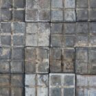 A spread of rare reclaimed square blue stable pavers showing a heavily weathered patina of worn faces and environmental discolouration