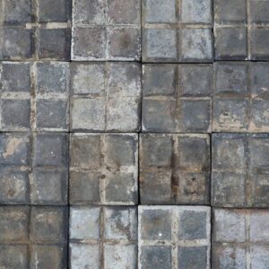 A spread of rare reclaimed square blue stable pavers showing a heavily weathered patina of worn faces and environmental discolouration