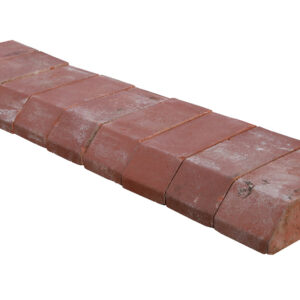 New old stock of red plinth header bricks showing the slight aged patina of time in storage