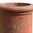 Detail of the roll top on a lightly weathered red roll top chimney pot with fabulous patina