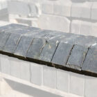 Weathered reclaimed solid blue squint bricks, used for changing the angle of a wall or helping create a bay window