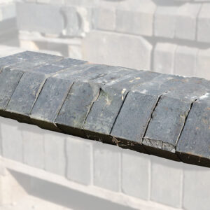 Weathered reclaimed solid blue squint bricks, used for changing the angle of a wall or helping create a bay window