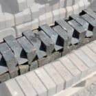 A batch of weathered reclaimed solid blue squint bricks, used for changing the angle of a wall or helping create a bay window