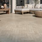 An elegant presentation of Spanish porcelain tiles in a herringbone pattern and showing the Taxos Sand finish that accurately emulates Egyptian limestone.