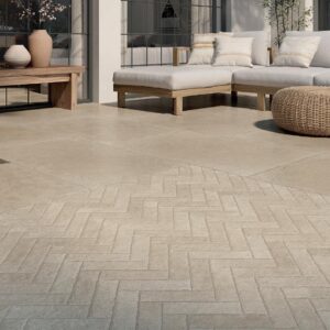 An elegant presentation of Spanish porcelain tiles in a herringbone pattern and showing the Taxos Sand finish that accurately emulates Egyptian limestone.