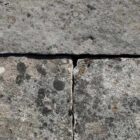 Detail of reclaimed and weathered limestone paving in a classic blue/buff colour and showing highly desirable aged patina