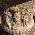 Detail of a beautifully weathered, reclaimed, composite stone urn with a dancing maidens decorative motif.