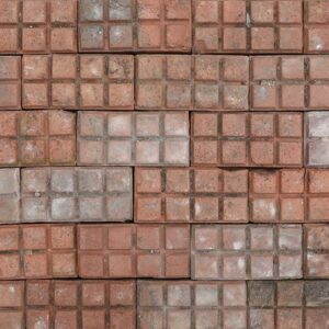 A collection of uncommon, weathered red stable pavers showing a fine patina of surface wear and discolouration