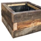 A bespoke hand crafted planter made from unused, seasoned oak sleepers, showing a fabulous patina and rich grain texture