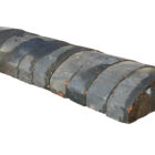A run of reclaimed Staffordshire blue domed wall copings showing an aged patina and remnants of mortar from previous use