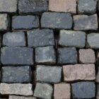 A spread of reclaimed blue grey granite cobbles with worn faces and authentic weathering and patina