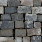 A spread of dry reclaimed blue grey granite cobbles with worn faces and authentic weathering and patina