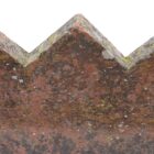 A detail of a ridge tile from a short run of 8 reclaimed cocks comb crested ridge tiles with an even patina of lichen and environmental discolouration.