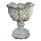 A beautifully weathered composite stone tulip design urn on an uncommon octagonal base