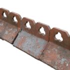 A short run of reclaimed double club, or trefoil, crested ridge tiles with a weathered patina of lichen and age related discolouration.
