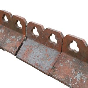 A short run of reclaimed double club, or trefoil, crested ridge tiles with a weathered patina of lichen and age related discolouration.