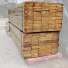 A large stack of new unbranded scaffold boards ready to build raised beds and rustic furniture but uncertified for use as scaffold boards in construction projects