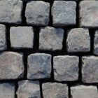 Reclaimed black basalt setts in brick bond pattern, showing the worn faces of pre-loved paving