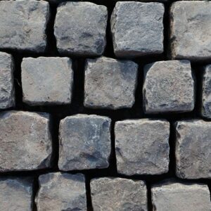 Reclaimed black basalt setts in brick bond pattern, showing the worn faces of pre-loved paving