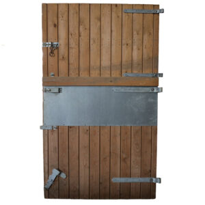 A reclaimed softwood stable door with galvanised fittings and stainless steel kick/bite plate
