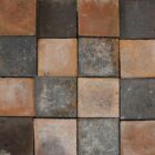 A batch of reclaimed red and blue quarry tiles laid in a classic chequerboard pattern, showing the pitted surfaces and discolouration commensurate with age