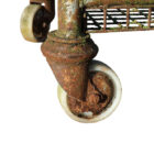Detail of the wheels on a reclaimed and heavily weathered Northampton shoe factory rack showing an authentic aged patina