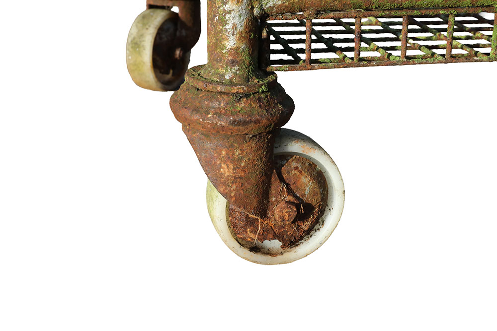 Detail of the wheels on a reclaimed and heavily weathered Northampton shoe factory rack showing an authentic aged patina
