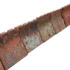 Part of a large run of reclaimed tooth top crested ridge tiles with a weathered patina of lichen and age related discolouration