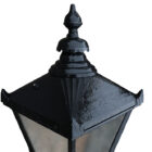 A detail of the finial top for the weathered Victorian style garden lantern with patina of peeling black paint